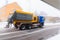 Truck spreading road salt on the icy and snowy road