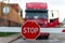 Truck standing at the barrier with a STOP sign.