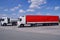 Truck stop on the highway. Trucks during a stopover. In the foreground a truck with a red tarpaulin in the background, a cistern