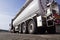 Truck stop next to the highway. A truck during a break, a tanker in the foreground