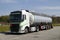 Truck stop next to the highway. A truck during a break, a tanker in the foreground