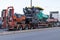 Truck to trailer transport equipment for road construction, asphalt pavers and road rollers. Riga, Latvia - 30 Sep 2021