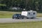 A truck towing a camper RV trailer on the highway