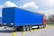 Truck trailer with blue awning trailer for cargo parked