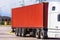 Truck trailer with a brown metal cargo container parked