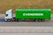 Truck with trailer and green container company Evergreen on city highway. Russia, Saint-Petersburg. 08 april 2020