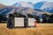 A truck and trailer unit travels west along a rural highway in Canterbury, New Zealand