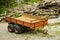 Truck trailer with wood in forest. Loading logs