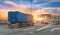 Truck transportation with separate trailer blue color drives among other cars heavy traffic along city highway during sunset sky