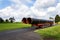 Truck transporting large steel oil and gas pipes, excessive load and heavy delivery