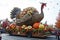 A truck transporting a sizable turkey on its back, A lively parade celebrating Thanksgiving with gigantic floats, AI Generated