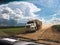 Truck travels along a dirt road next to a soybean plantation, seen through the dirty