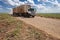 Truck travels along a dirt road on a sugar cane farm in the municipality of