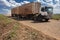 Truck travels along a dirt road on a sugar cane farm in the municipality of