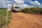 Truck travels along a dirt road on a sugar cane farm in the municipality of