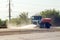 Truck watering the road with water. Irrigation of the road from dust, environmental protection