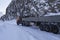 Truck on winter road under a rock.
