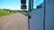 Trucker in sunglasses reflecting in side mirror of moving car. Man driving lorry riding to destination through