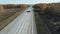 Trucks and cars go along the highway. Two sided way asphalt highway in rural landscape at summer sunny day. Top view on