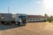 Trucks with containers in the parking lot along the highway against the background of clouds. The concept of logistics, transport