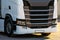 Trucks with containers in the parking lot along the highway against the background of clouds. The concept of logistics, transport