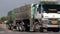 A trucks drives on the rural road and turning on a crossing