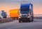 trucks goes on highway on sunset