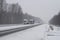 Trucks on the highway in a blizzard