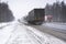 Trucks on the highway in dirty weather, Dangerous driving conditions in winter in cloudy weather.