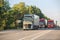 Trucks moving along a suburban highway