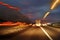 Trucks moving down a highway at night