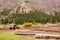 Trucks on the road during repairs after flood in a valley between mountains of Central Asia