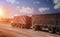 trucks speeding on the highway and sunset for Transport industr