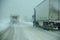 Trucks on winter highway during snowstorm