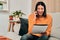 True ambition makes things happen wherever you are. a young woman using a smartphone while working on the sofa at home.