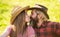 True feelings. Enjoying life. Love and harmony. Bearded cowboy in hat kissing adorable girlfriend. Couple in love