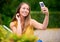 True happiness needs no filter. a carefree young woman taking a selfie on her phone at the park.