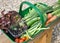 A trug full of organic home grown fruit and vegetables