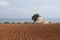 Trulli grain store in ploughed field in Puglia, Italy. Landscape image.