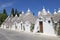 Trullo with symbol on the roof along the street at Alberobello, Apulia, Italy