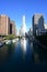 Trump Tower Chicago and surrounding buildings reflected in Chicago River.