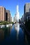 Trump Tower Chicago and surrounding buildings reflected in Chicago River.