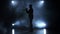 Trumpeter in a smoky studio playing a wind instrument