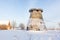 truncated windmill, a house and snow