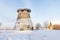 Truncated windmill, a house and snow