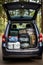 The trunk of a car full of suitcases and things. Travel by car.