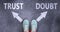 Trust and doubt as different choices in life - pictured as words Trust, doubt on a road to symbolize making decision and picking