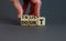 Trust or doubt symbol. Businessman flips wooden cubes and changes the word doubt to trust. Beautiful grey background, copy space.