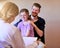 They trust her with their familys health. Shot of a pediatrician consulting with a man and his young daughter in her