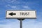 Trust road sign, arrow on blue sky background